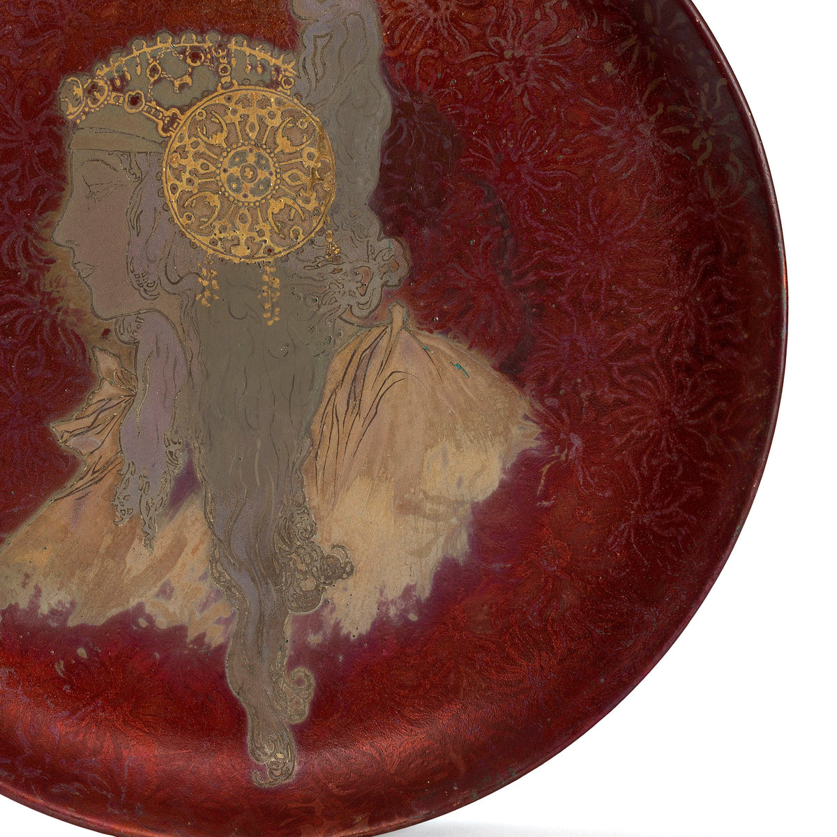 Macklowe Gallery A French Art Nouveau iridescent enamel-glazed ceramic charger by Clément Massier, after a design by Alphonse Mucha, depicting a woman's profile in Byzantine dress and jewels.  
