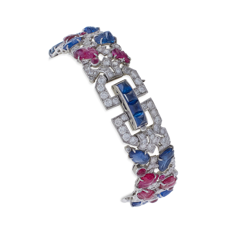 
                      
                        Macklowe Gallery Carved Ruby, Sapphire and Diamond Tutti Frutti Strap Bracelet
                      
                    